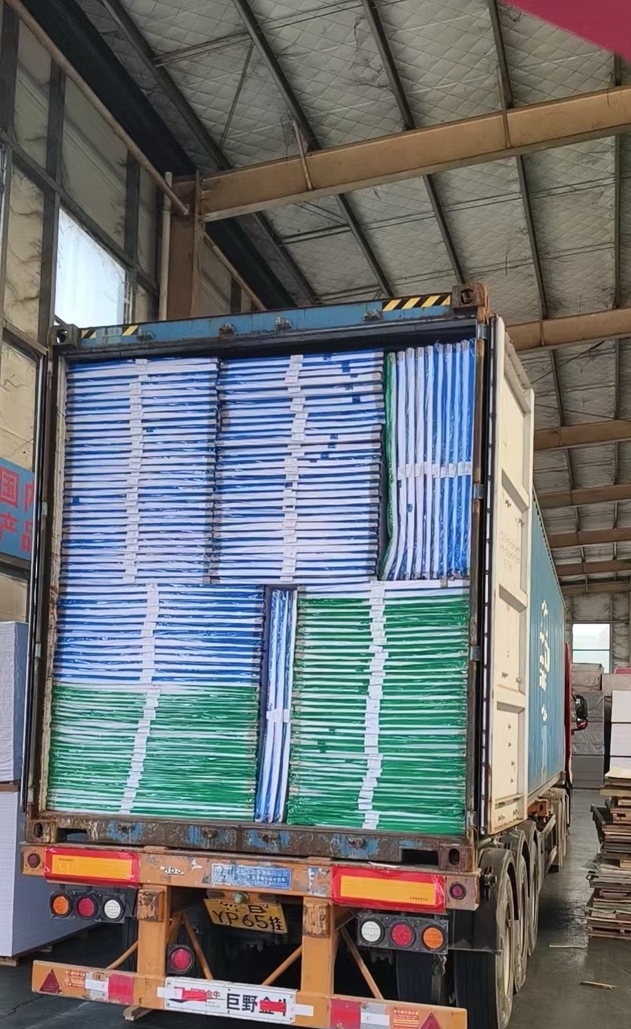 Colored PVC foam board sheets loaded into container